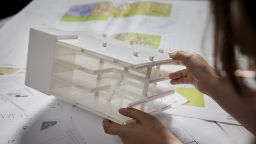 A student inspecting a building model