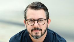 Man sitting down with glasses on