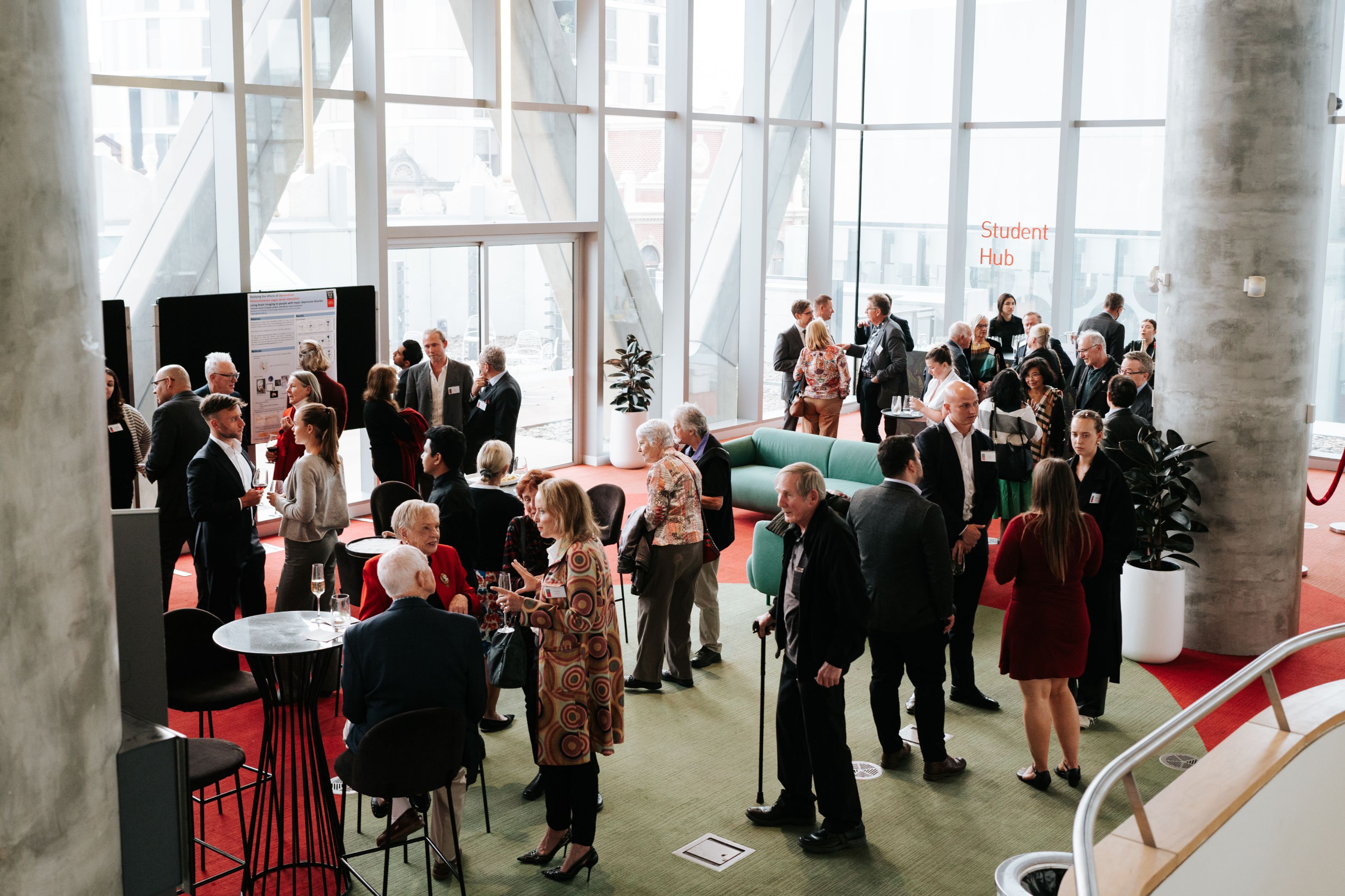 People networking at a Barbara Dicker Oration event, discussing mental health research.