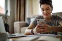 Female student studying and listening to music at home