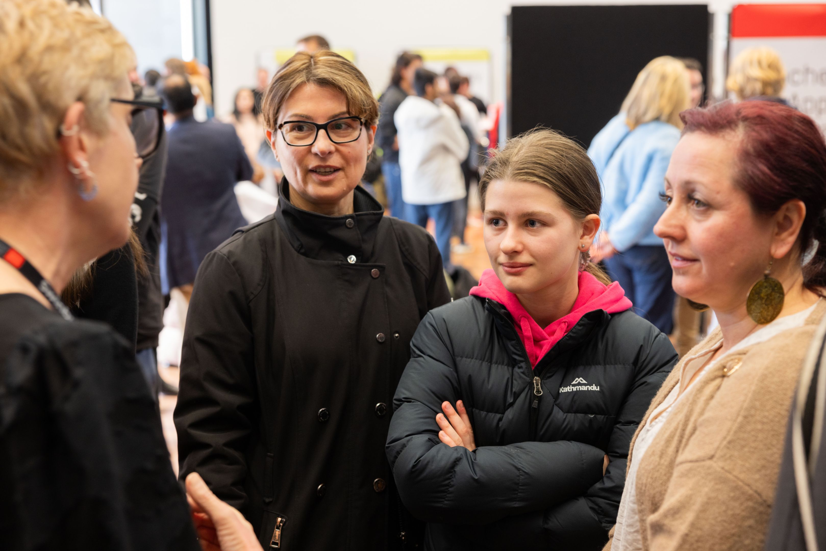 A high school student and her family speak with an advisor at Swinburne Open Day 2024.