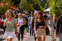 a group of students at o-week walk through campus in the sun