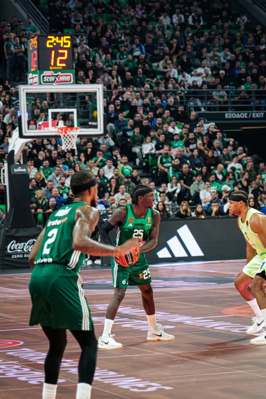 Panathinaikos 3 Basketball player preparing to throw the ball mid-game