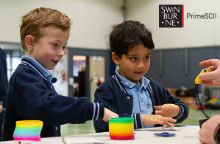 Two young boys engaged in physics education
