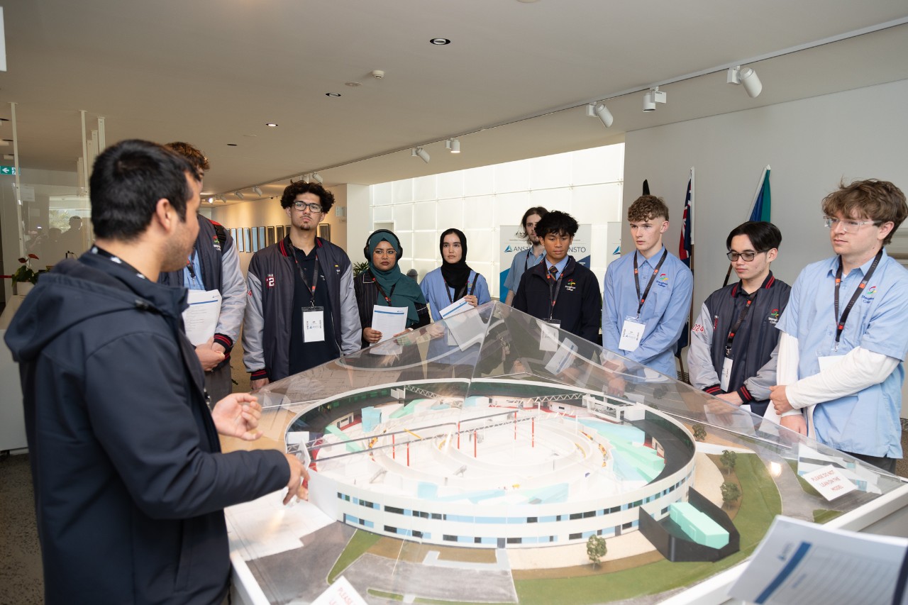 High school Students standing in a museum looking at an exhibition. 