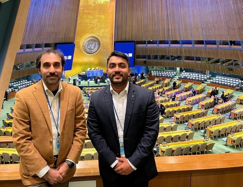 Vishnu and Dr Alhassan standing in front of the UN Water Conference venue in New York