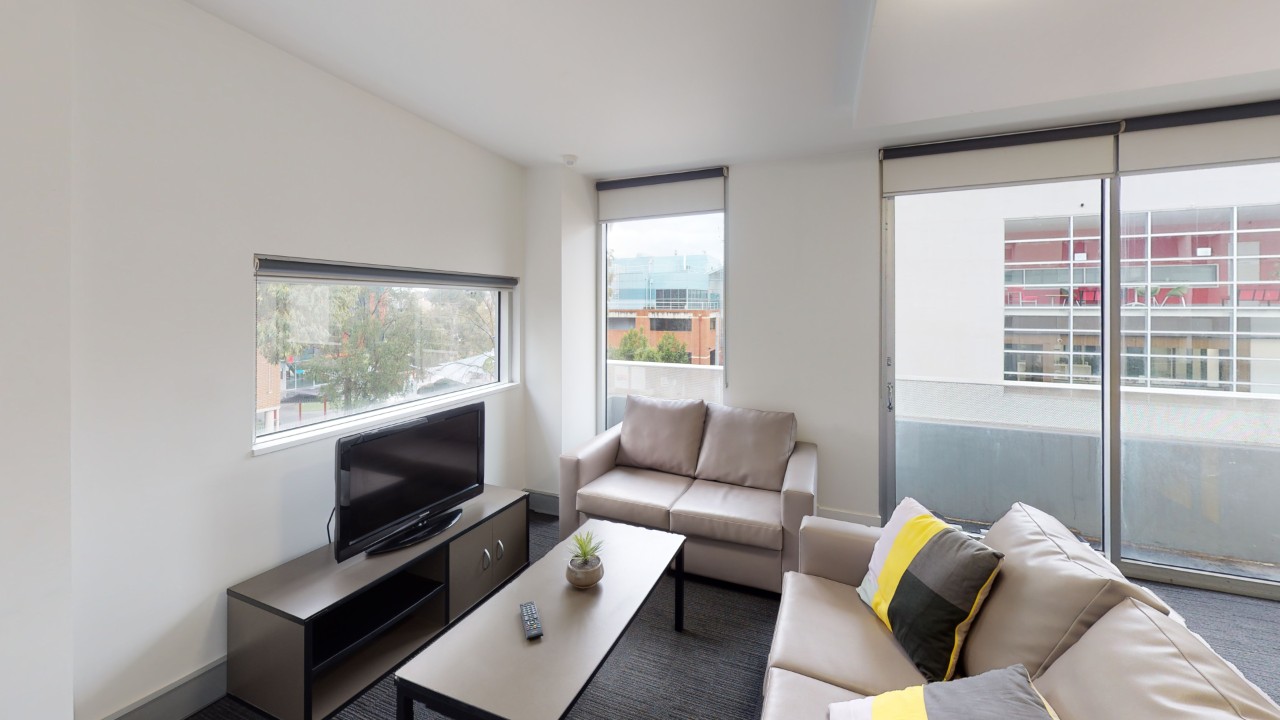 A cosy living space with a TV, two couches and a coffee table