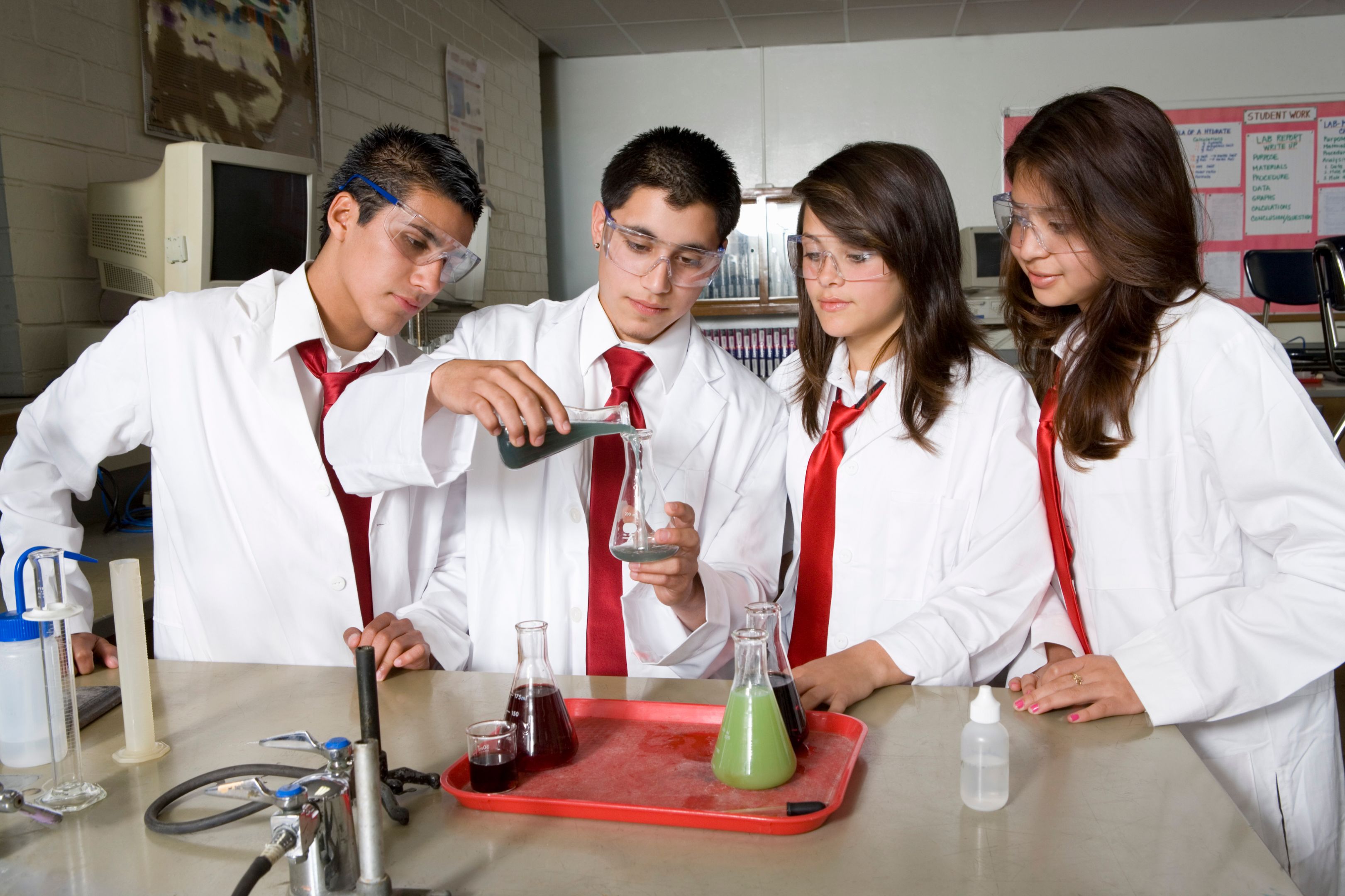 High school students conducting a science experiment. 