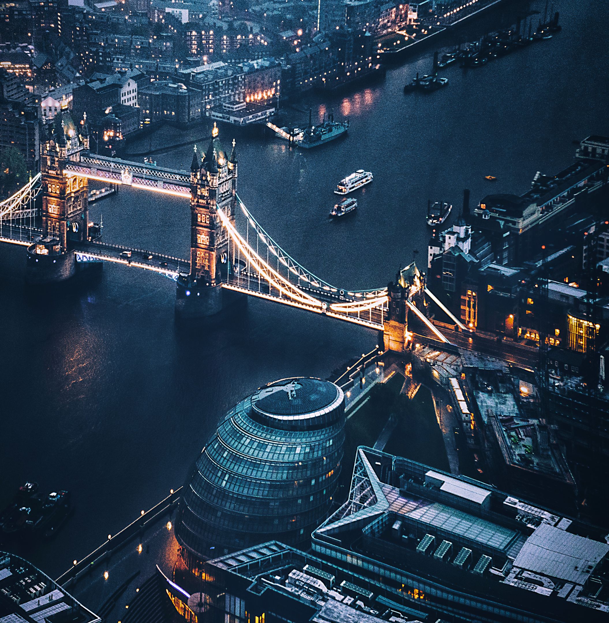 Aerial shot of London at night tower bridge aerial view at night