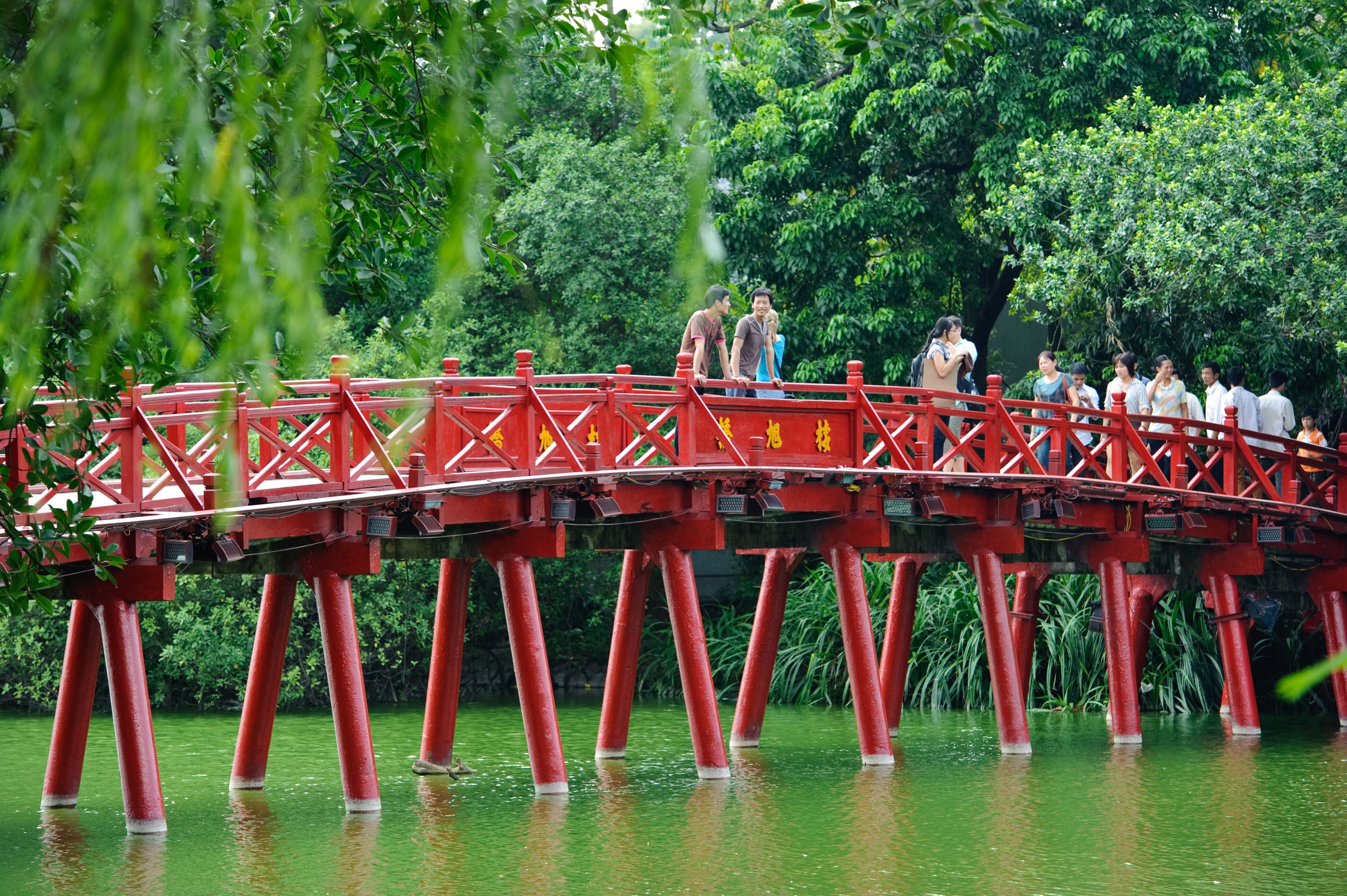 Hanoi Red Bridge, Vietnam Hanoi red bridge. The wooden red painted bridge over the Hoan Kiem Lake connects the shore and the Jade Island on which Ngoc Son Temple stands