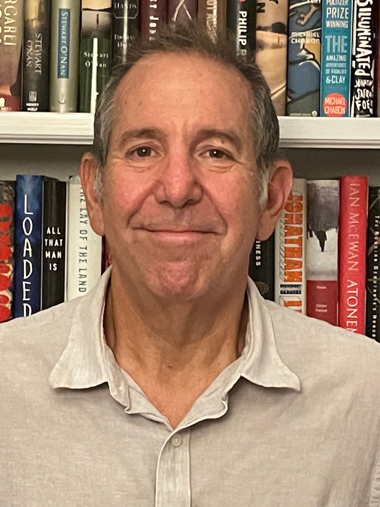 Headshot of Barry Rosenfeld standing in front of a bookshelf,