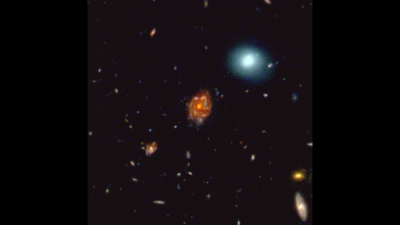 a picture of space, stars and a white glow surrounds a larger red glow in the middle of the picture, this red glow displays the newly discovered galaxy disk the Big Wheel
