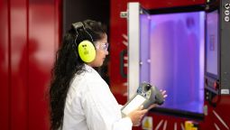 A researcher using equipment to monitor an experiment in the Factory of the Future