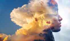 Double exposure, close-up of an African American girl and layers of stunning fluffy clouds