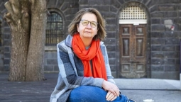 Jane Farmer. Woman sitting looking into the camera