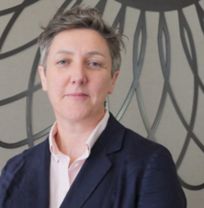 Headshot of Professor Nicola Carr wearing pink shirt and navy blazer 