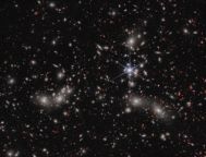 A foreground star to the right of the image centre, displays JWST’s distinctive diffraction spikes. Bright white sources surrounded by a hazy glow are the galaxies of Pandora’s Cluster, a conglomeration of already-massive clusters of galaxies