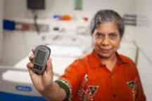 Professor Nilmini Wickramasinghe holding her DiaMonD (Diabetes Monitoring Device)