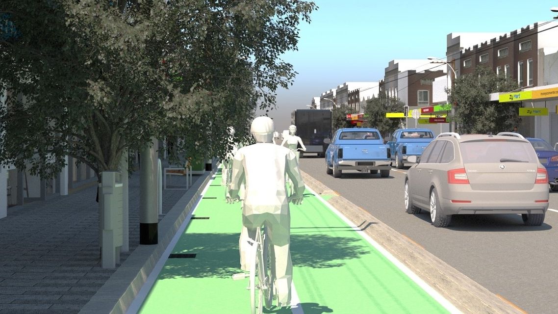 Presented as a virtual reality simulation, an animated figure is riding a bicycle in a bike lane on a city street, with cars driving past.