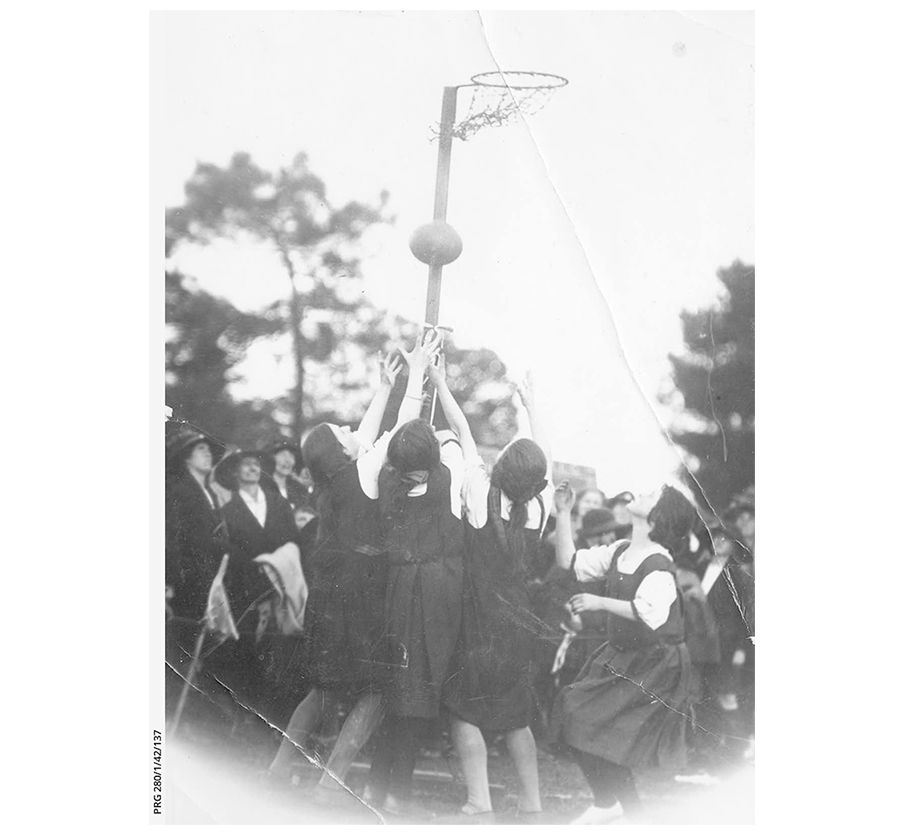 Schoolgirls playing netball 1923 Black and white photo of school girls reaching up for the ball as they play netball