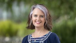 Jo Bradshaw wearing a blue cardigan