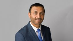 Terrence Yakub in a suit with a grey background