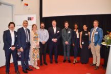 group of finance and accounting experts pose together for a photo in a lecture theatre 