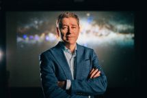 Australian Science: Man in a suit posing for the camera with his arms crossed