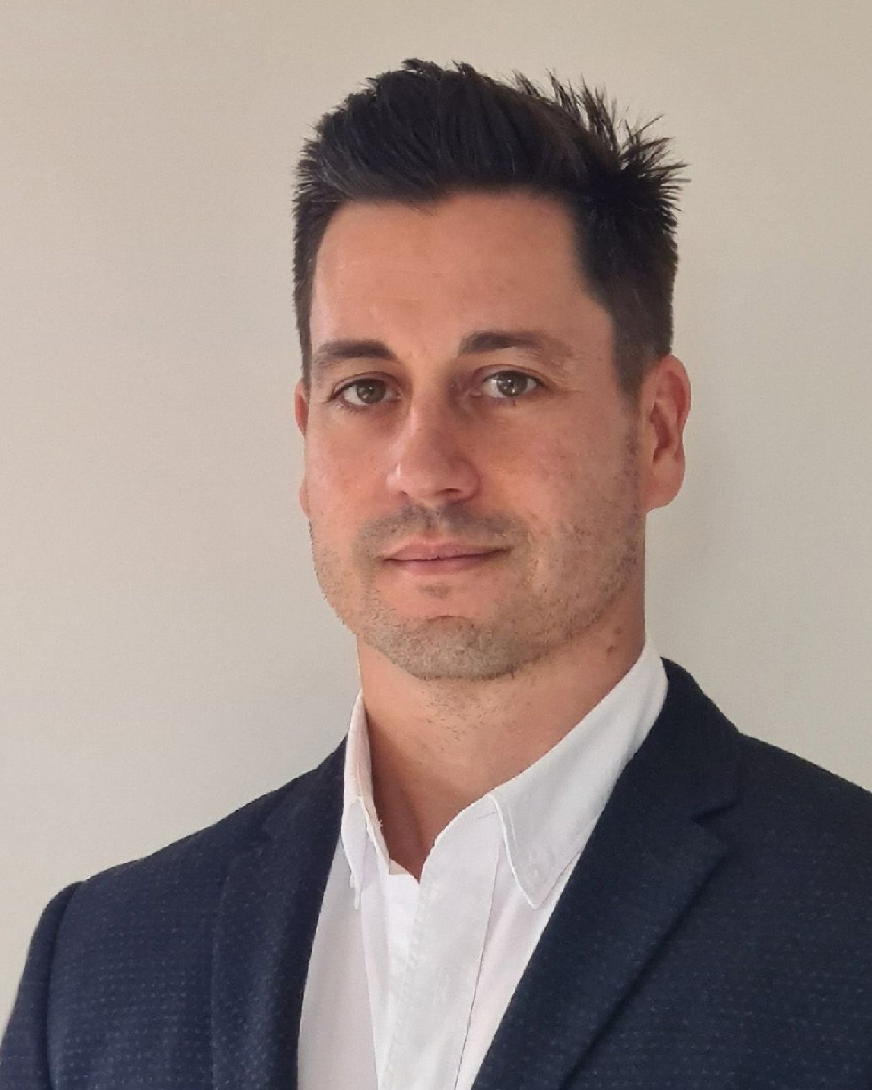 A professional looking man wearing a suit with a serious look. 