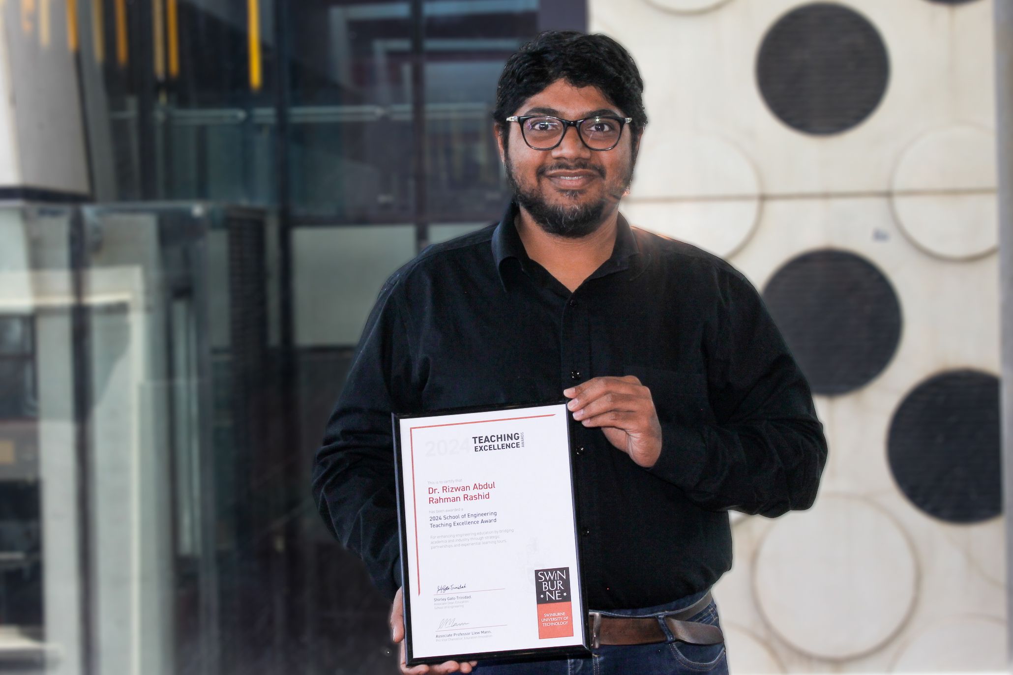 School Teaching Excellence Award Recipient Dr Rizwan Abdul Rahman Rahshid holding his award.