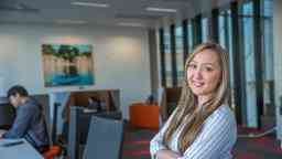 Female psychophysiology student smiling to camera arms folded