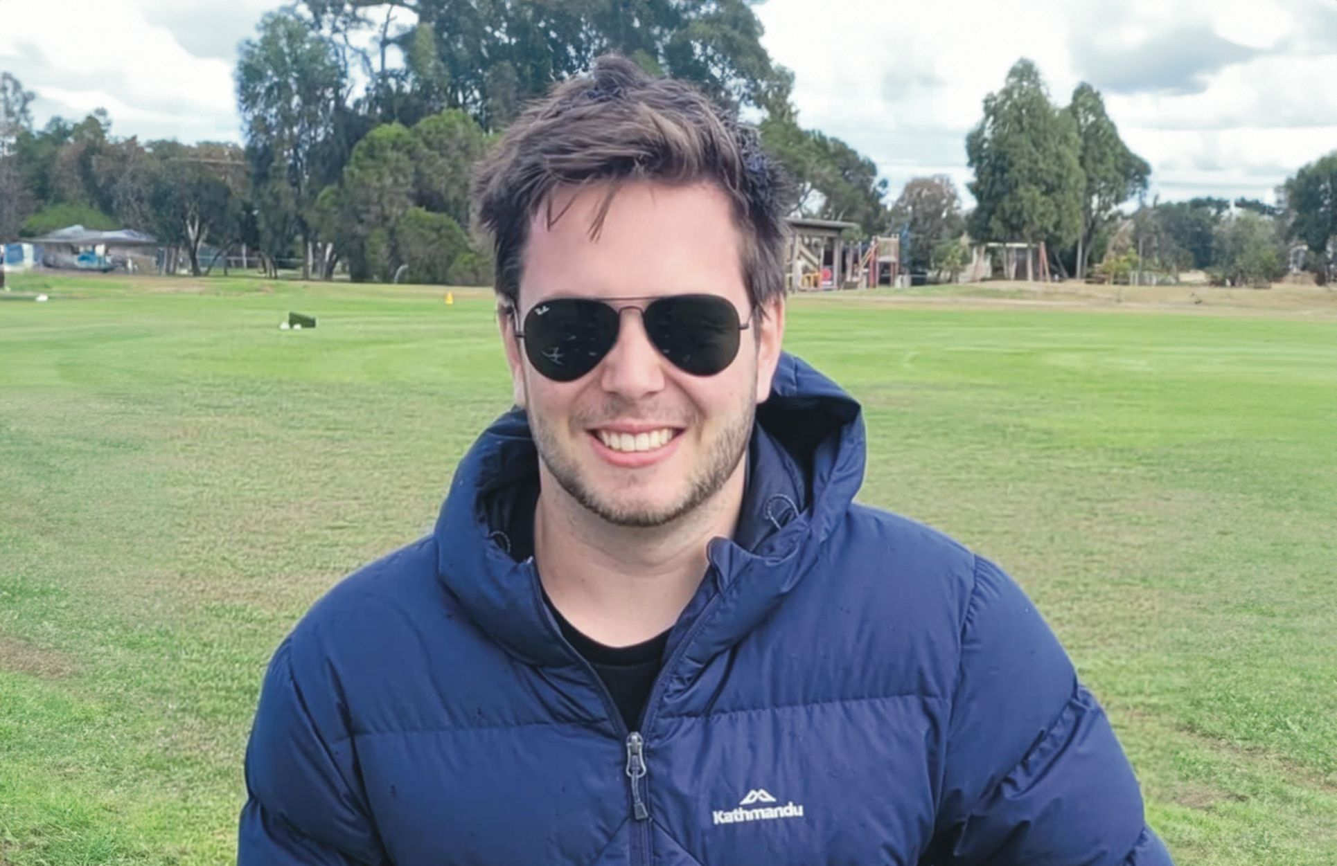 Professional Placement student Lachie wearing sunglasses and a blue jacket