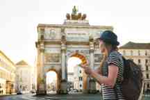 A tourist girl with a backpack looks sights in Munich in Germany