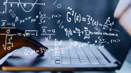 Abstract image of mathematical formulas and laptop screen and keyboard.