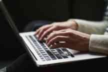 Girl typing on MAC computer