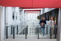 two students standing talking on walkway